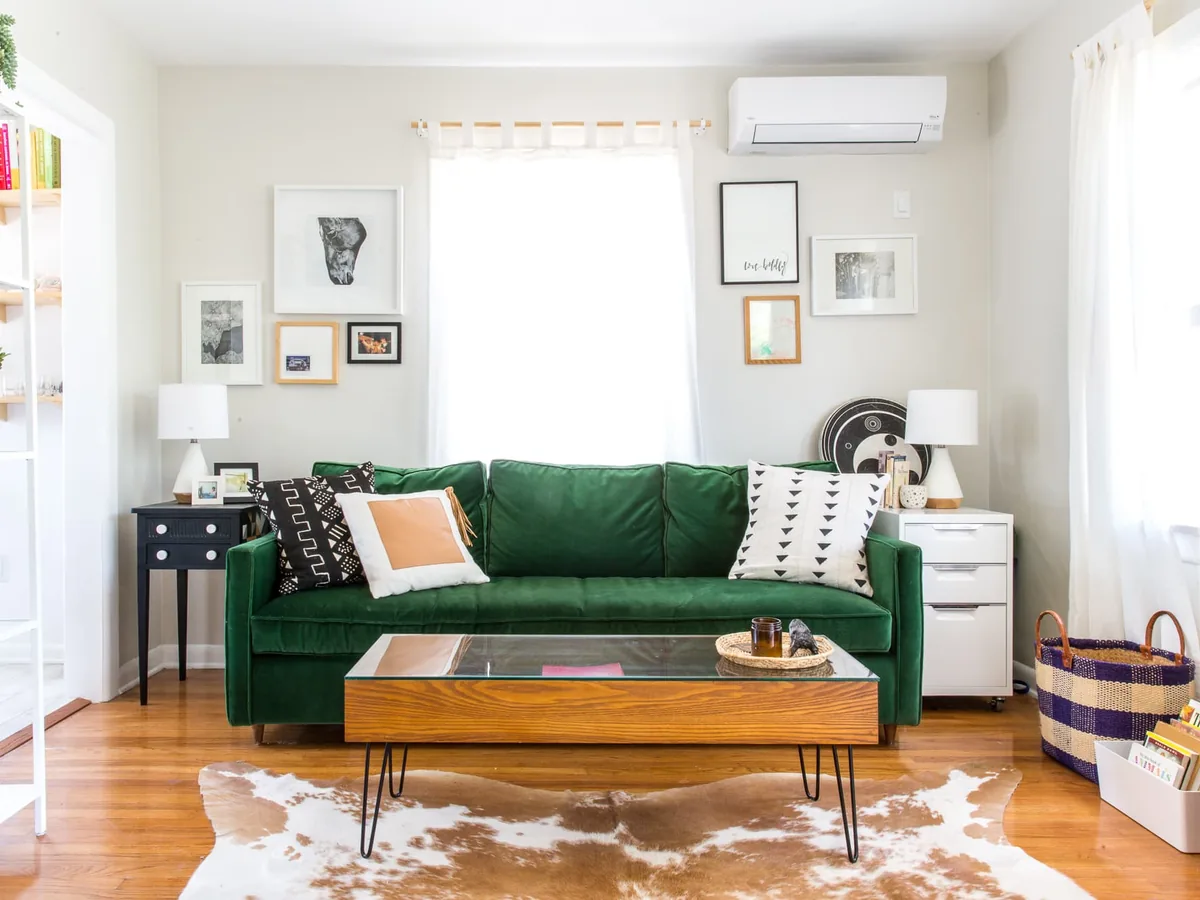 Wall-mounted mini split head above the seating in a living room
