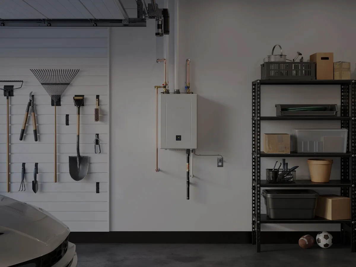 Wall-mounted gas tankless water heater with copper piping in a garage