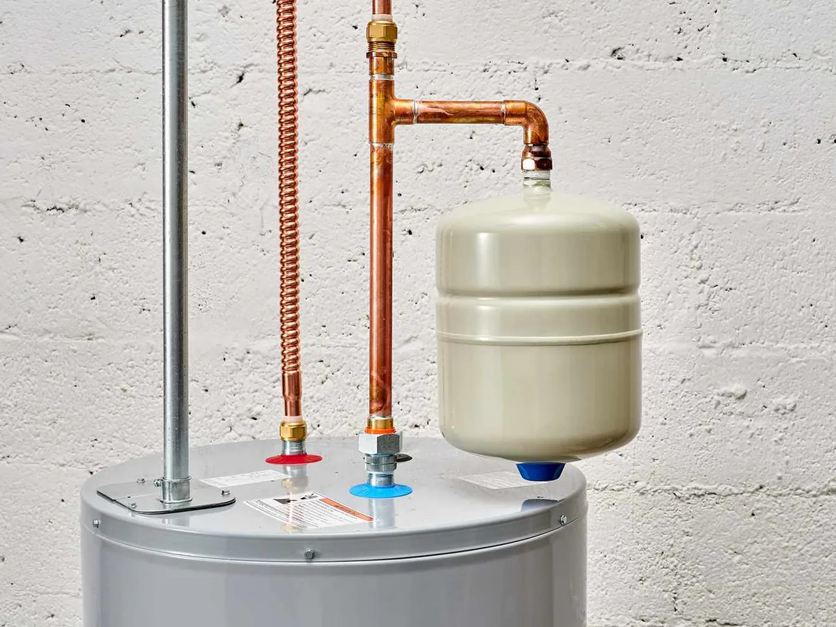Newly installed tank water heater with copper risers and an expansion tank